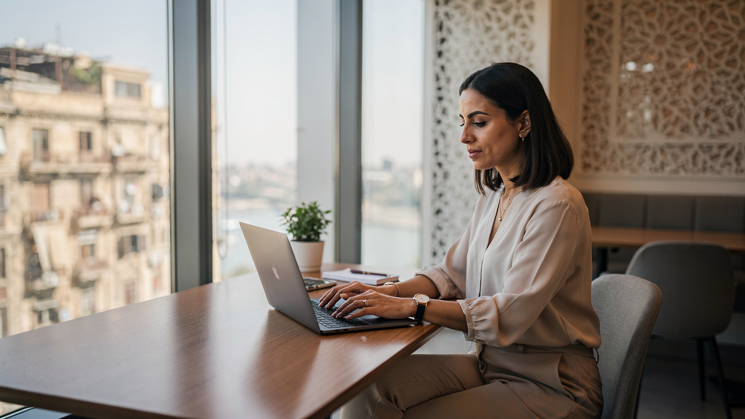 A digital nomad works from a vibrant co-working space in Downtown Cairo, showcasing modern work culture amidst historic surroundings.
