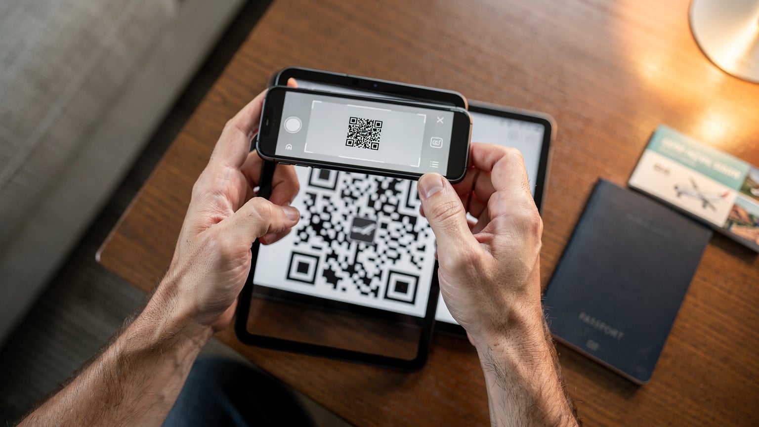 Un viajero activa su eSIM en un smartphone, con el código QR en una tableta, en la comodidad de su casa antes de su viaje a Chile.