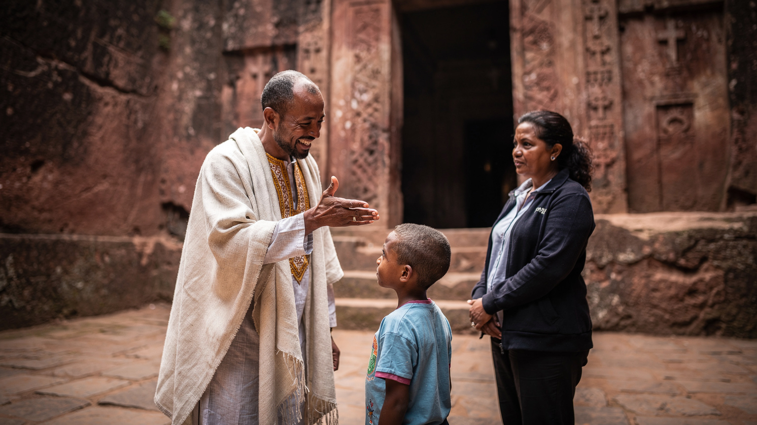 A local Ethiopian guide engaging with a curious child and parent at the rock-hewn churches of Lalibela, explaining the history with hand gestures.