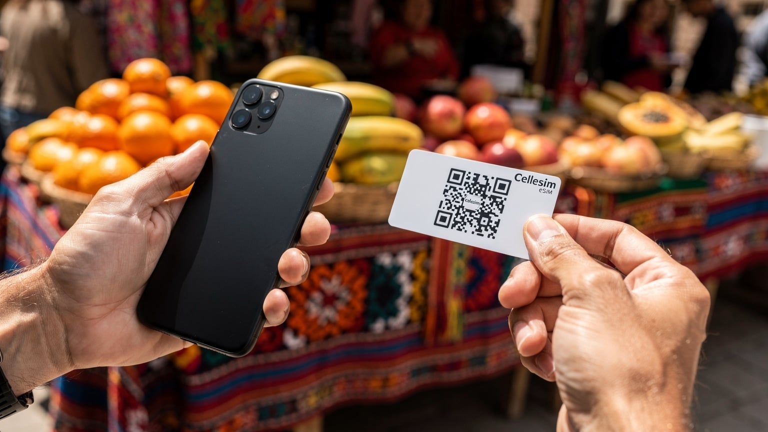 A close-up of a person's hands holding a smartphone, with a Cellesim eSIM QR code clearly displayed on a separate card, against the backdrop of a slightly blurred, colorful market stall in La Paz, Bolivia.