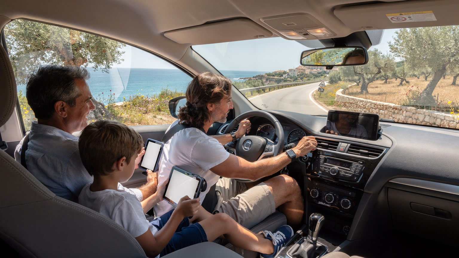 Une famille en voiture sur une route côtière en Italie, les enfants regardant des tablettes à l'arrière, les parents consultant un smartphone à l'avant, avec des paysages méditerranéens en fond.