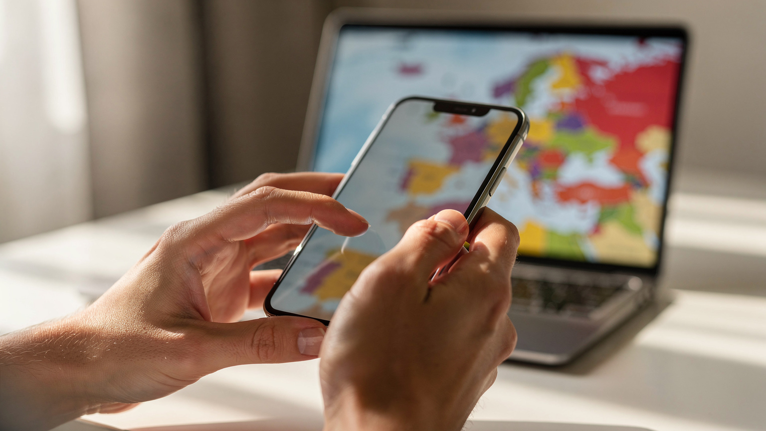 Close-up of hands holding a smartphone, with a blurred map of Europe in the background, illustrating seamless digital navigation.