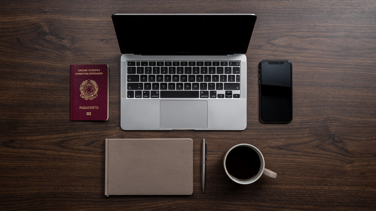 Una scrivania ben organizzata con un laptop aperto, uno smartphone con l'interfaccia di un'app eSIM, un passaporto, un taccuino e una tazza di caffè, il tutto su un tavolo di legno scuro.
