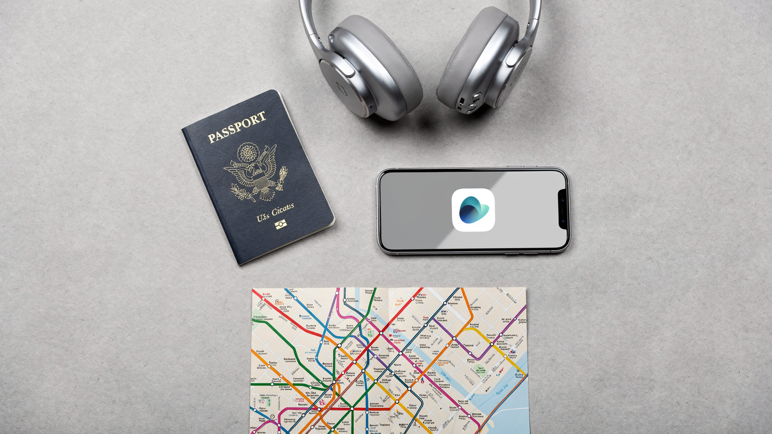 An overhead flat-lay of travel essentials: a passport, a smartphone with a Cellesim app icon visible, noise-canceling headphones, and a local transit map for a European city.