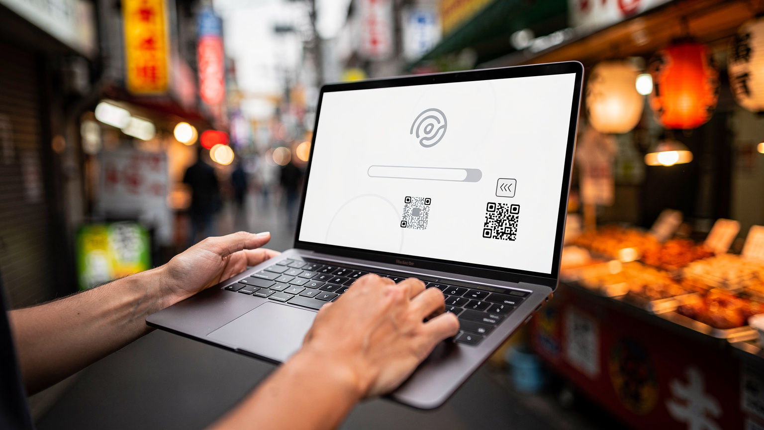 A person's hands holding a laptop, displaying a Cellesim eSIM activation screen, with a blurry background of a bustling city street food market in Tokyo.