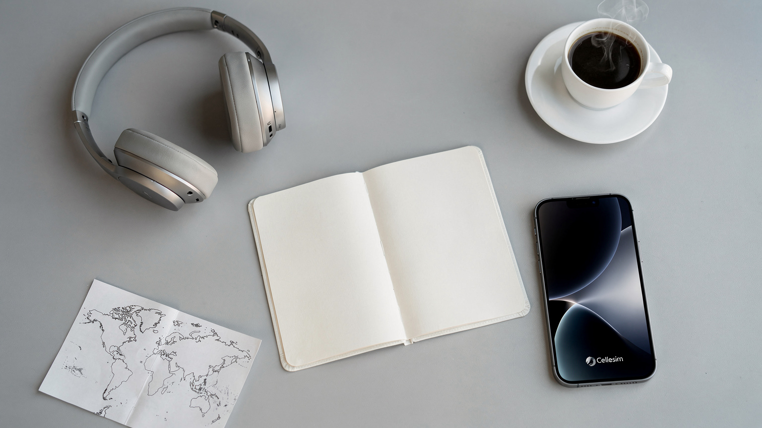 An editorial flat-lay showing a passport, an iPhone with a Cellesim logo on the screen (no actual UI), noise-canceling headphones, and a small, stylized world map, all neatly arranged on a modern airport lounge table, evoking readiness for global travel.