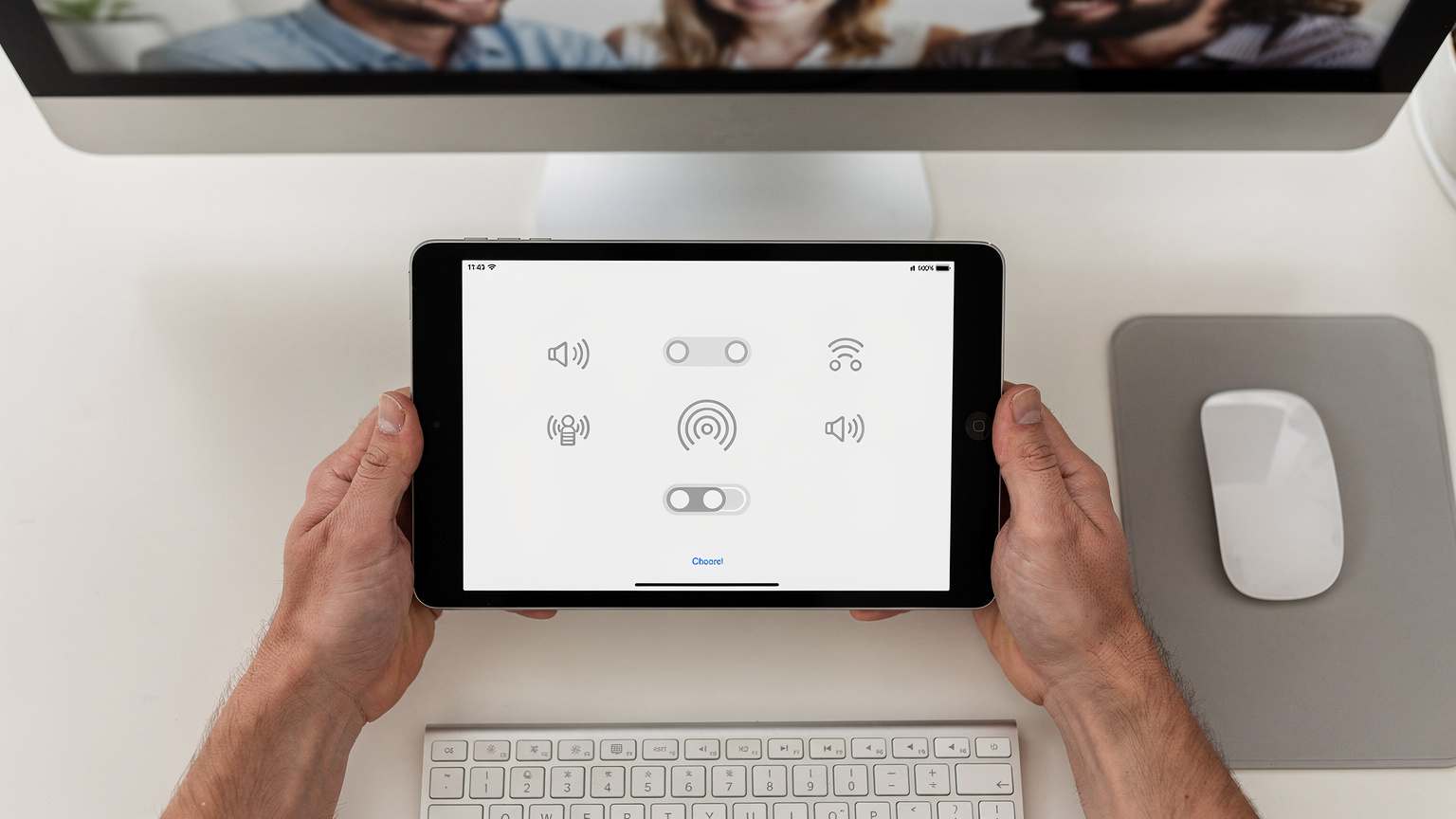 Un primo piano sulle mani di una persona che tiene un iPad, mostrando un'interfaccia utente minimalista con icone di rete, come parte di una guida didattica, con uno sfondo morbido di una scrivania da lavoro.