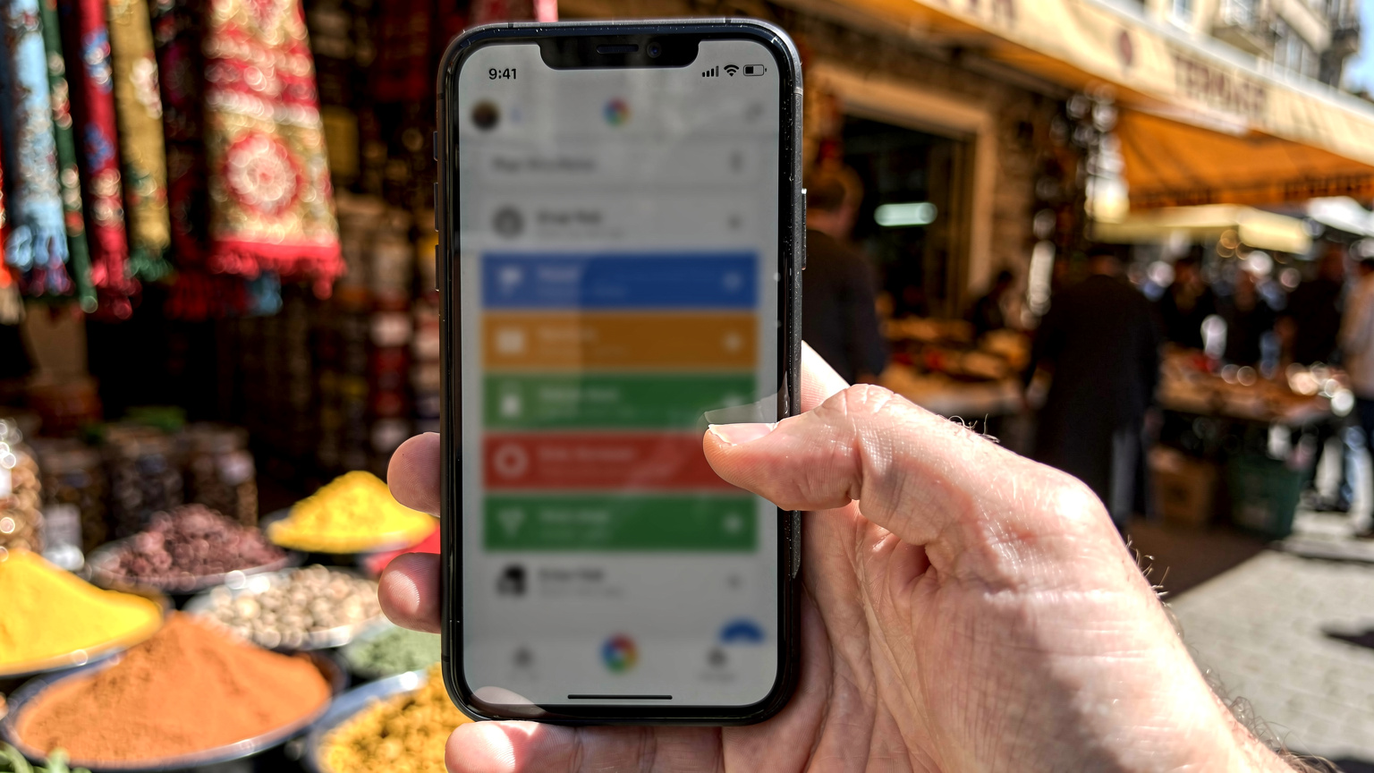 An Android phone displaying network settings, with a thumb poised to tap the eSIM option, in an Istanbul market.