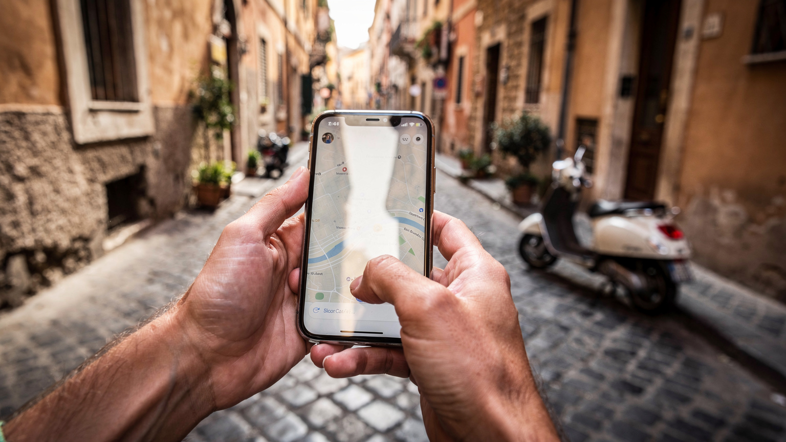 A close-up of a traveler's hands using a smartphone to navigate a map app, with a classic Roman street scene gently blurred in the background.