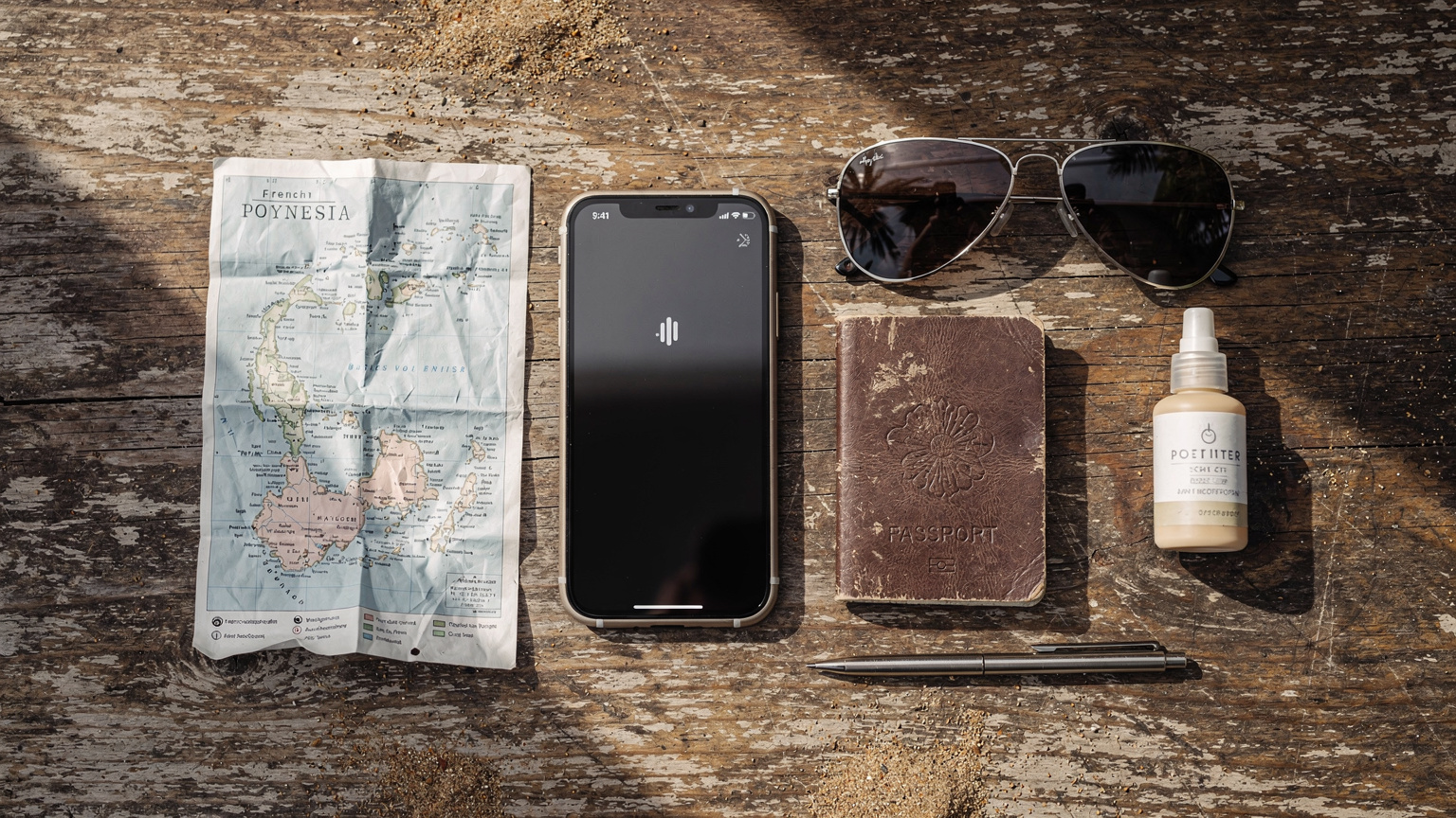 An organised flat-lay of a backpacker's essentials, including a smartphone with an active eSIM icon, passport, map, and sunglasses, on a distressed wooden table.