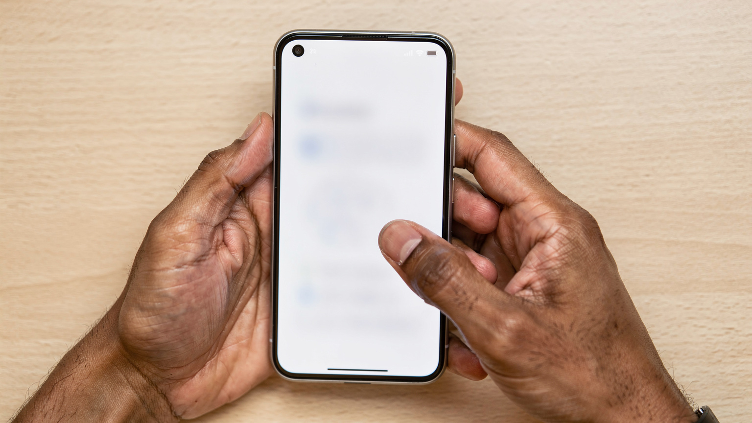Close-up of hands navigating the settings menu on a Pixel 9, illustrating the process of switching between eSIM profiles.
